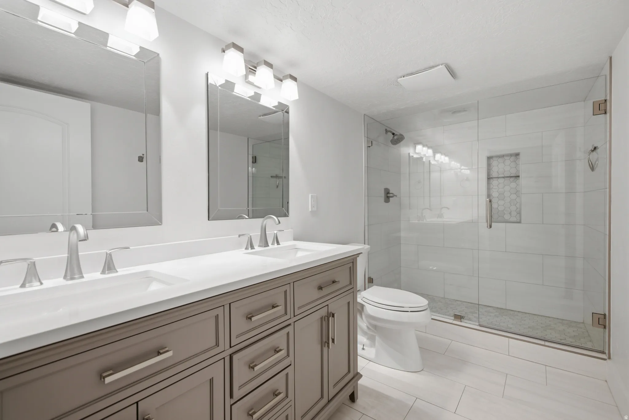 Dual vanity with integrated sinks and a light-toned countertop