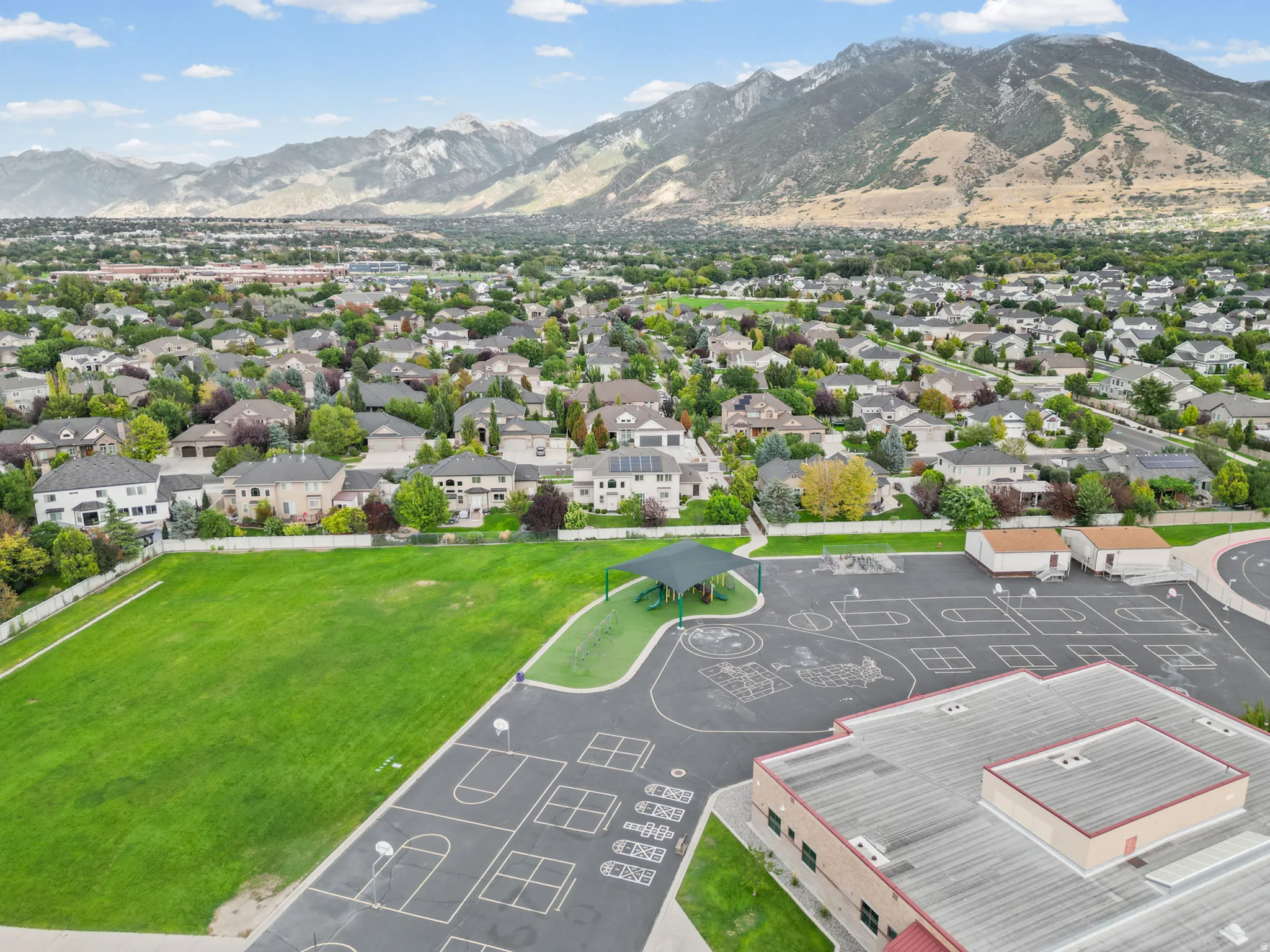 Expansive residential neighborhood with mature trees and mountain backdrop