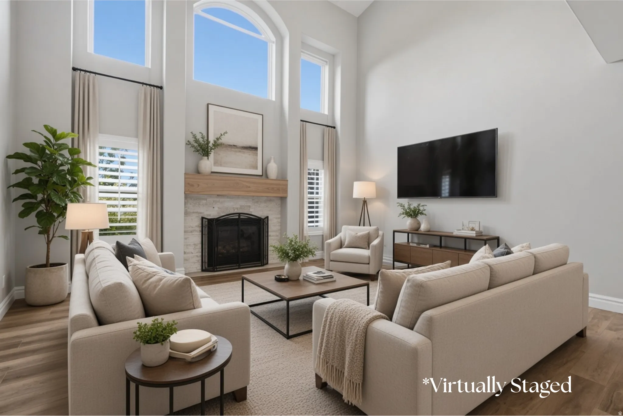High ceilings with upper transom windows, stone-clad fireplace with wood mantel, wood-finish flooring, and plantation shutters
