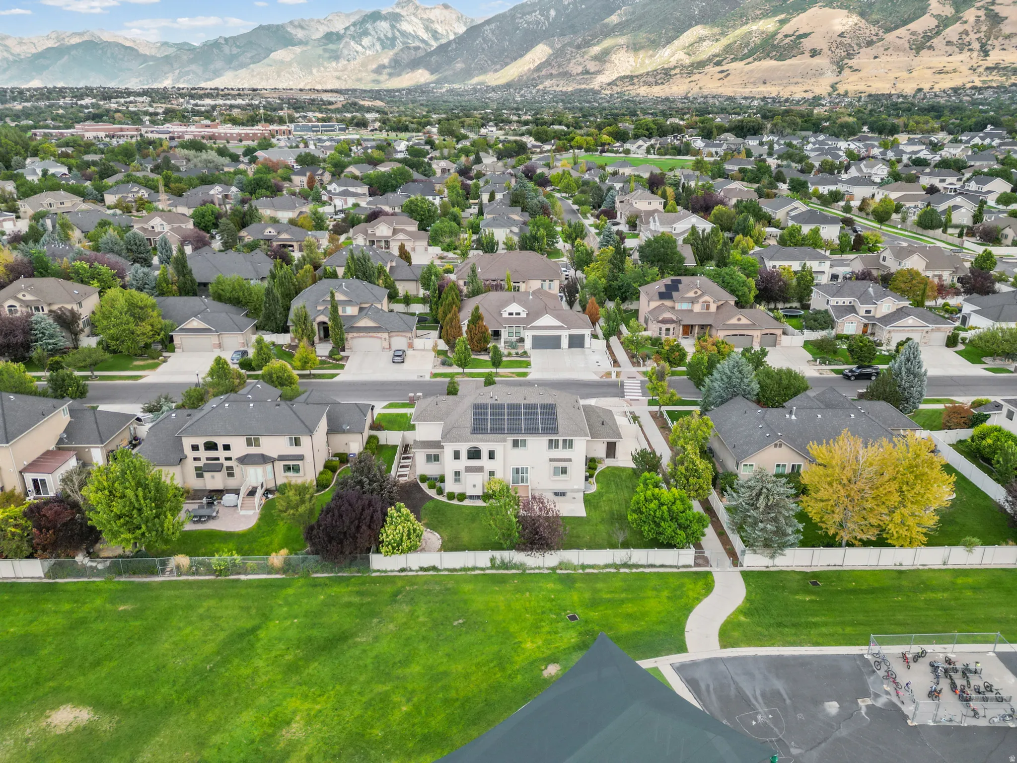 Expansive residential neighborhood with mature trees and mountain backdrop