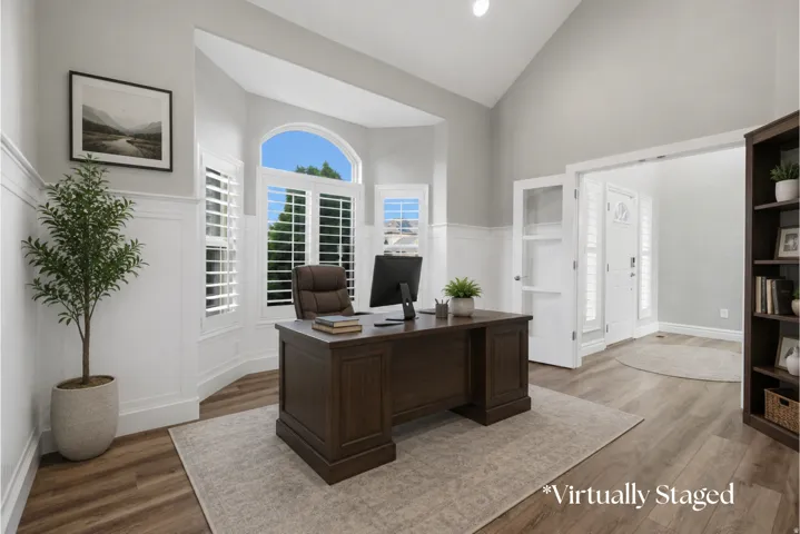 Vaulted ceiling, wainscoting, bay window with plantation shutters, wood-finish flooring, and glass-paneled double doors