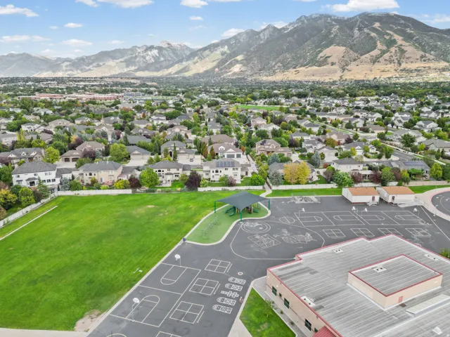 Expansive residential neighborhood with mature trees and mountain backdrop