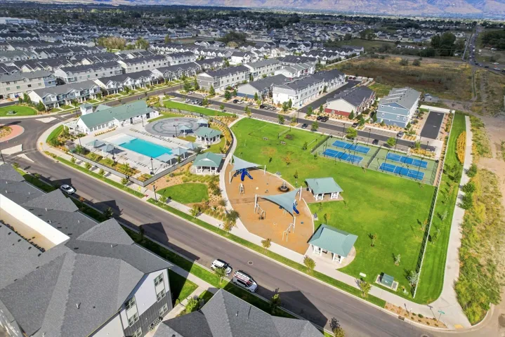 Community amenities featuring a swimming pool, shaded playground, tennis courts, and expansive green space