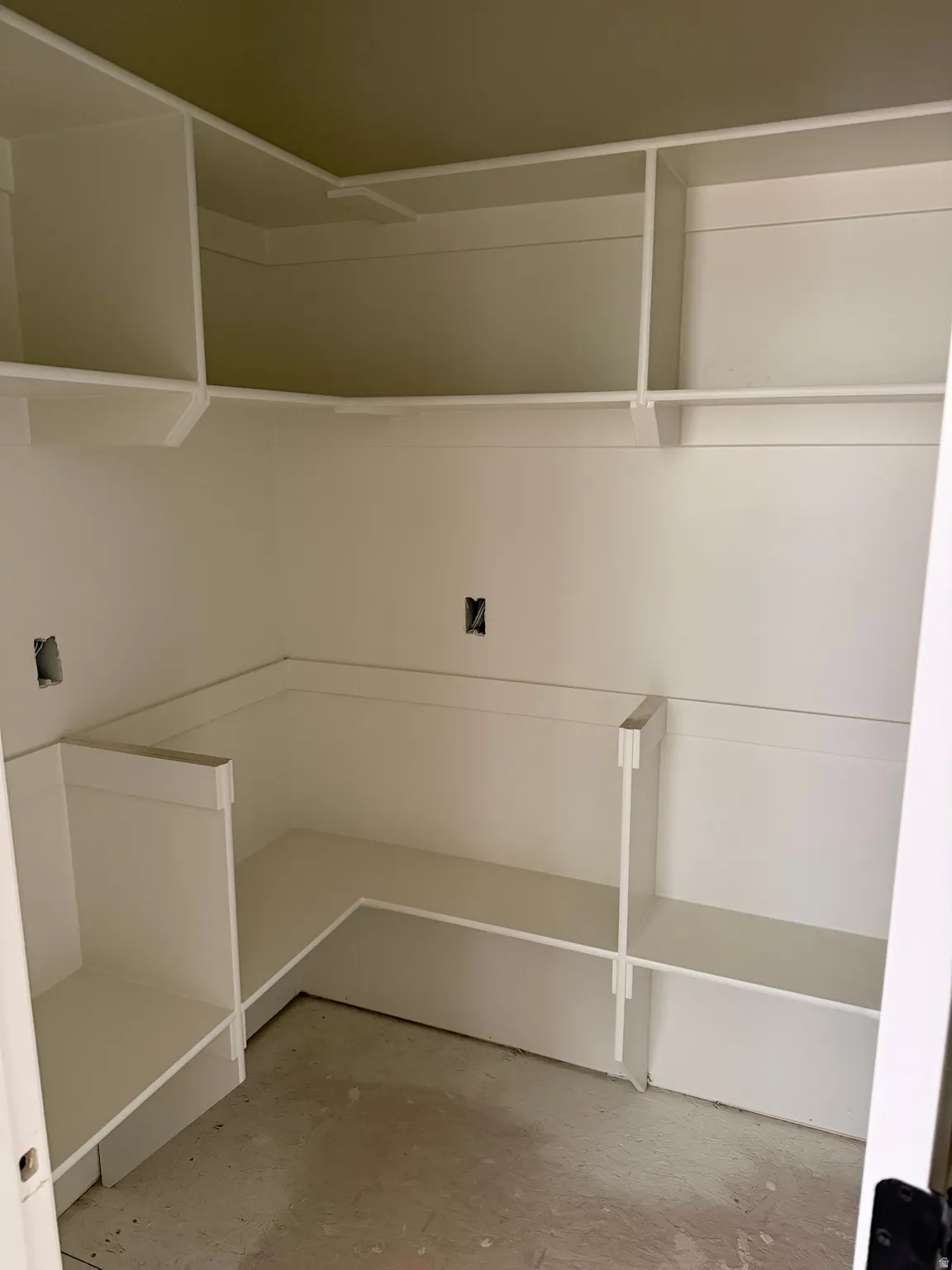 Built-in closet shelving, integrated hanging rods, corner shelving unit, lower storage compartments, and a fresh white finish