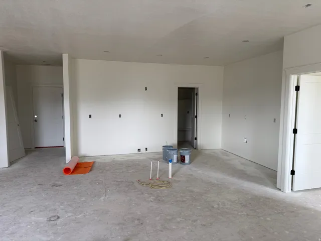 Spacious open-concept interior with expansive drywall surfaces, recessed ceiling lighting, and multiple electrical outlets throughout