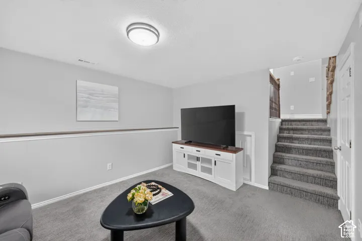Recessed lighting, light gray wall paint, carpeting, white baseboards, and a white paneled door