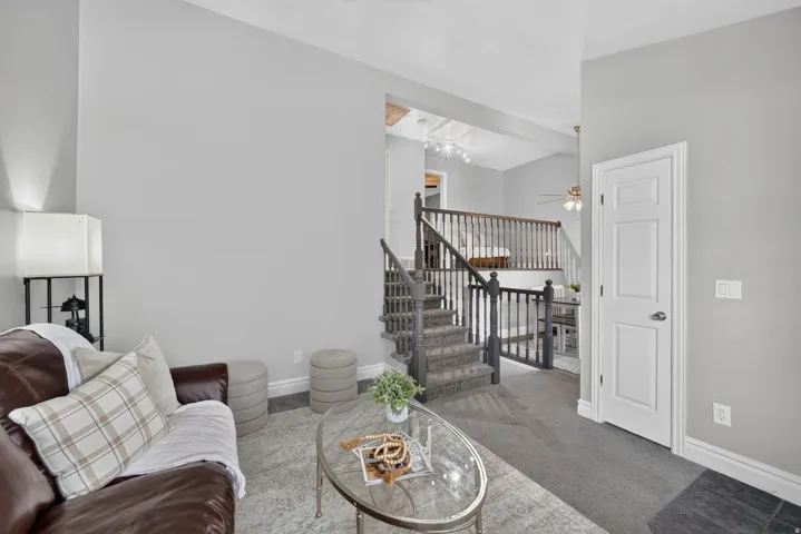 Carpeted staircase with dark wood-finish newel posts and railings