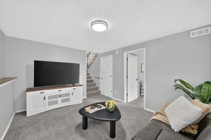 Wall-to-wall carpeting and neutral gray walls