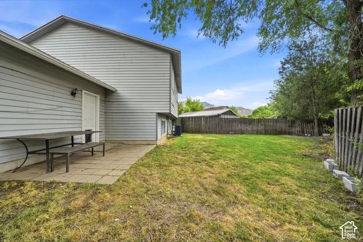 Spacious backyard with a paver patio and full privacy fencing