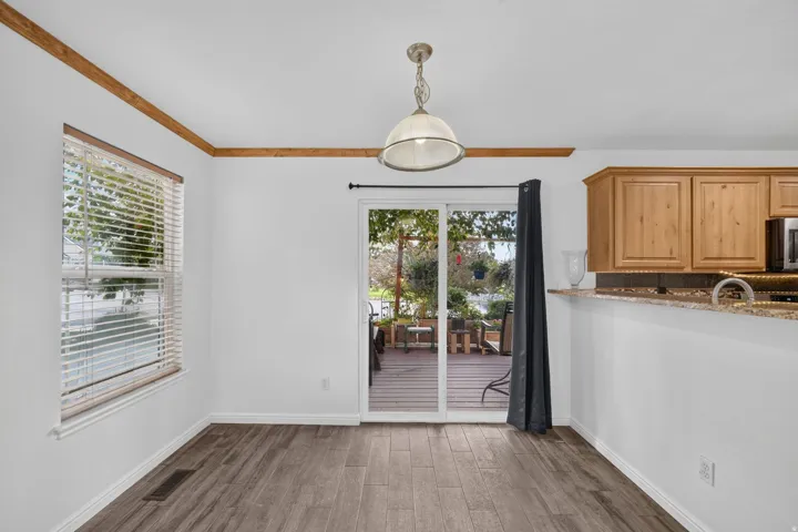 Wood-finish flooring, white walls, and wood trim accents