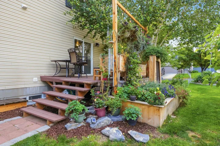 Wood-finish deck with steps, sliding glass door, and vinyl siding
