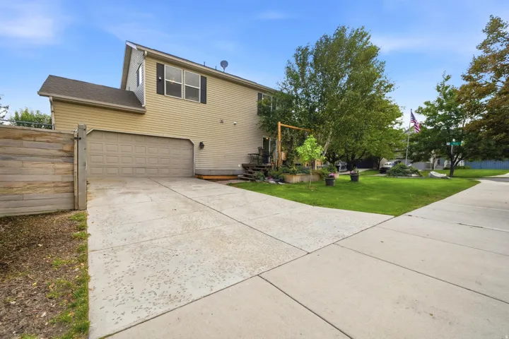 Two-car garage with a concrete driveway and light-colored siding