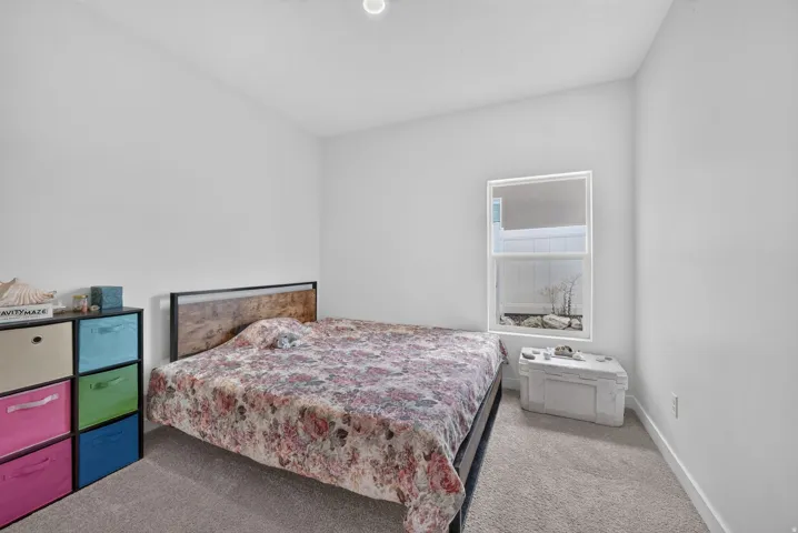 Recessed ceiling lighting, white painted walls, and gray carpet