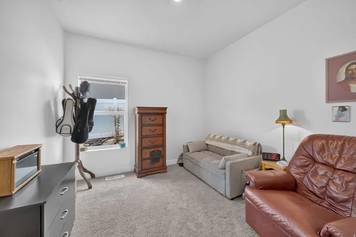 Carpeted flooring, white walls, and a single window with a white frame