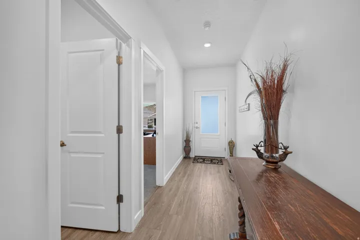Wood-finish flooring throughout the hallway