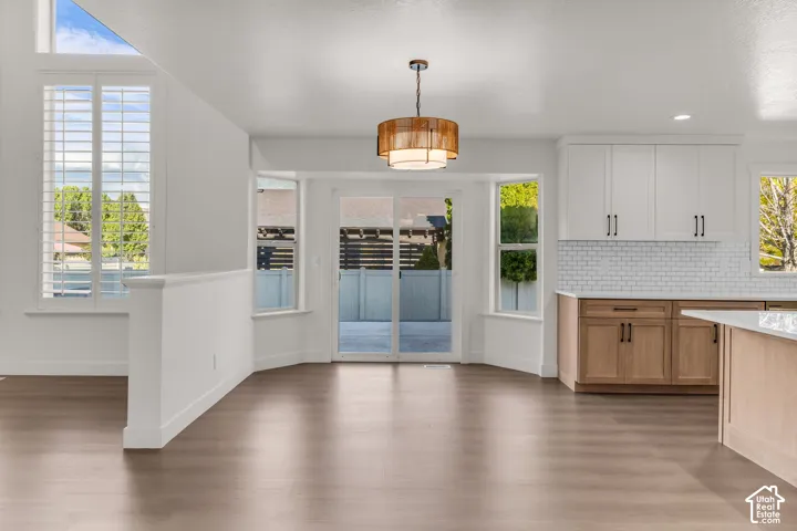 Wood-finish flooring throughout, with a decorative ceiling light fixture