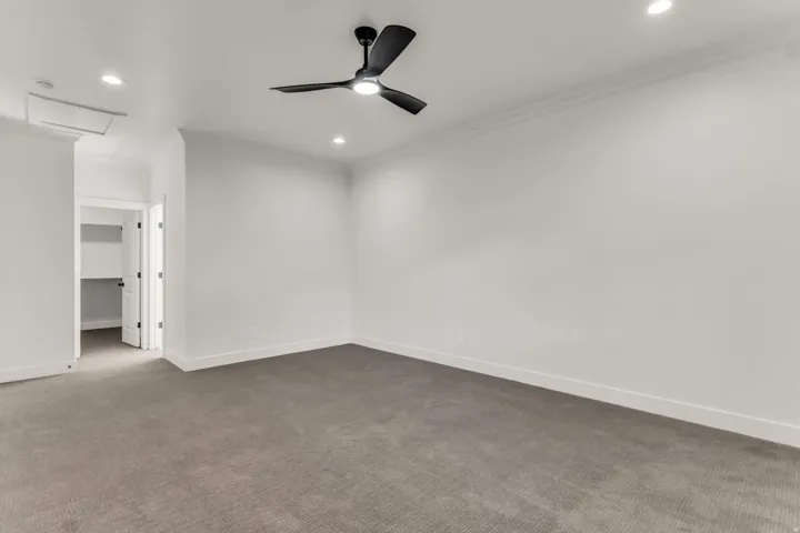Recessed lighting, crown molding, and a matte black ceiling fan