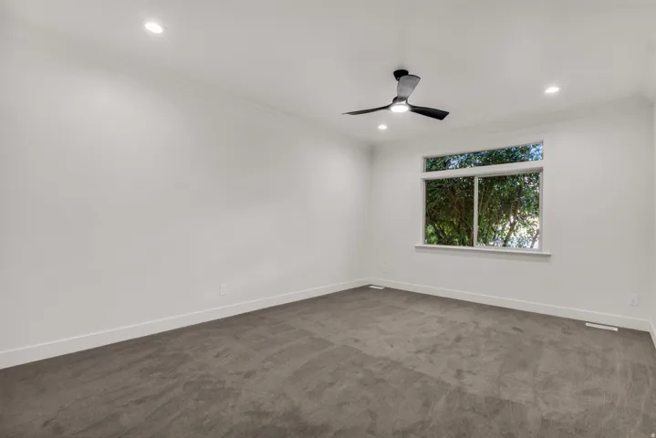Recessed lighting, crown molding, ceiling fan, white trim, and a window with white casing