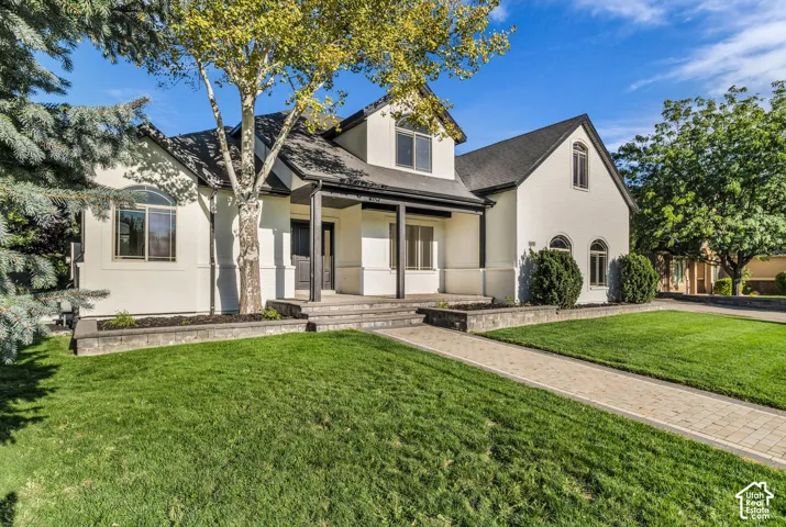 White stucco exterior with black trim accents and arched windows