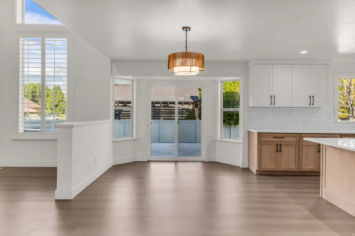 Wood-finish flooring throughout, with a decorative ceiling light fixture