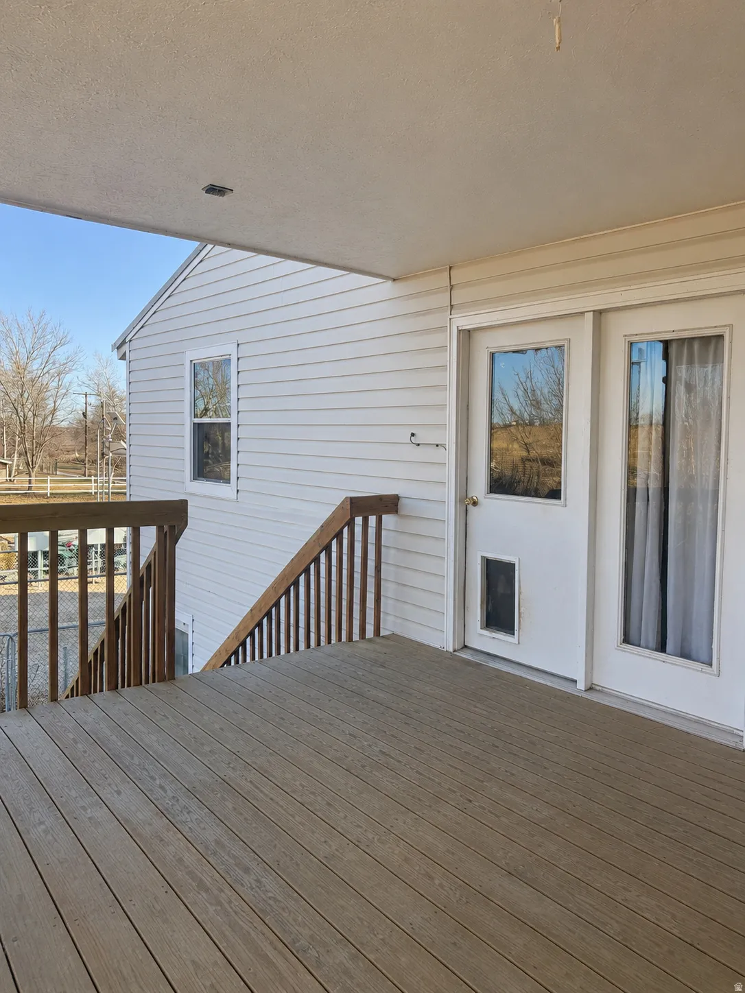 Outdoor deck featuring wood-finish decking and wood railings