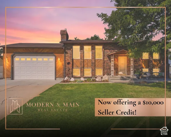 Brick and wood-paneled exterior with an attached garage, covered entryway, and a manicured lawn