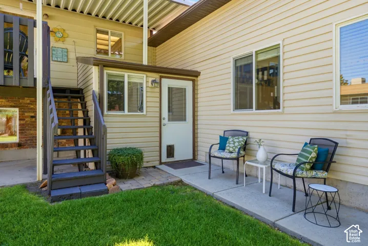 Stairs down from the back deck off the kitchen and door into the downstairs entryway and entry into the flex space.