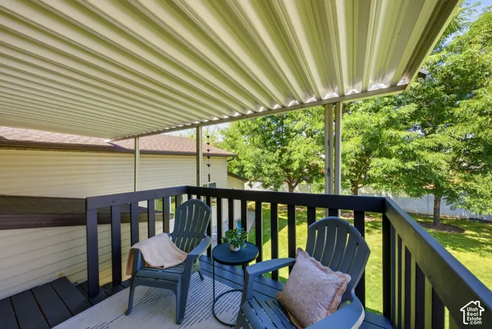 Covered back deck off the upstairs kitchen with access down to the yard