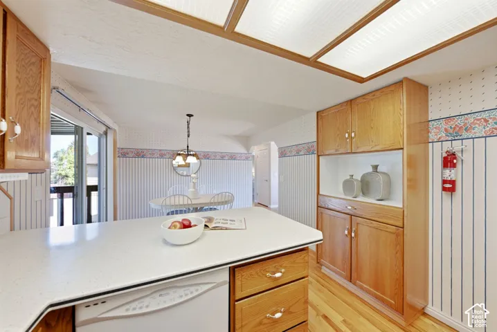 Kitchen Island with view into the dining room and the sliding glass door out to the back deck with access to the yard.