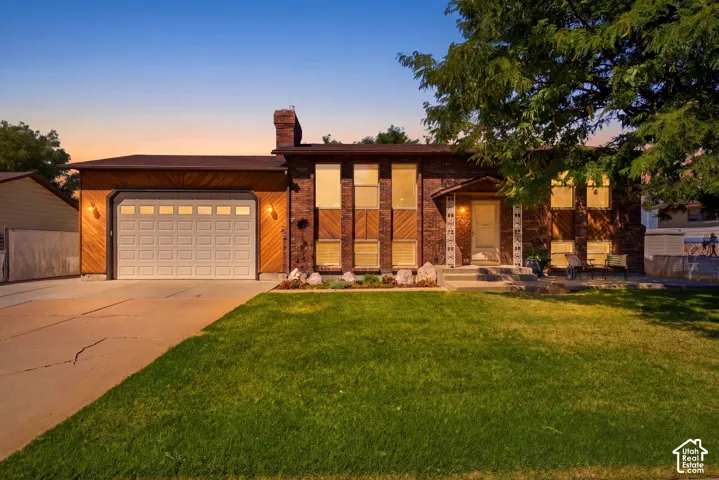 Welcome to 4737 S 3600 W - 10' tall garage doors and extra driveway space.