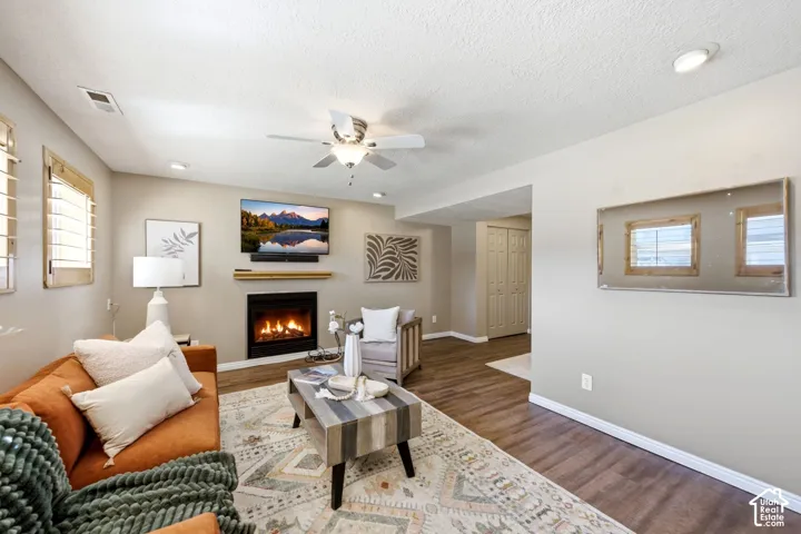 Basement living room with ample natural light, fireplace, and LVP flooring