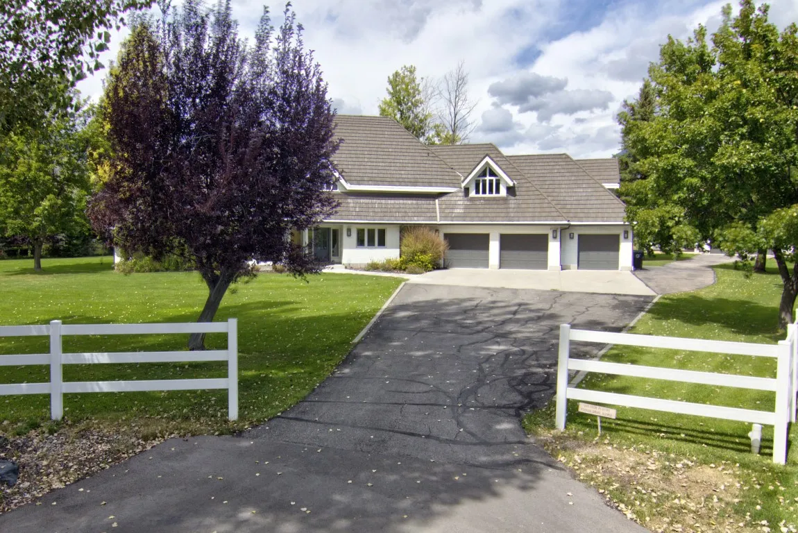 Single-story residence with a gray shingle roof, white siding, and a three-car garage