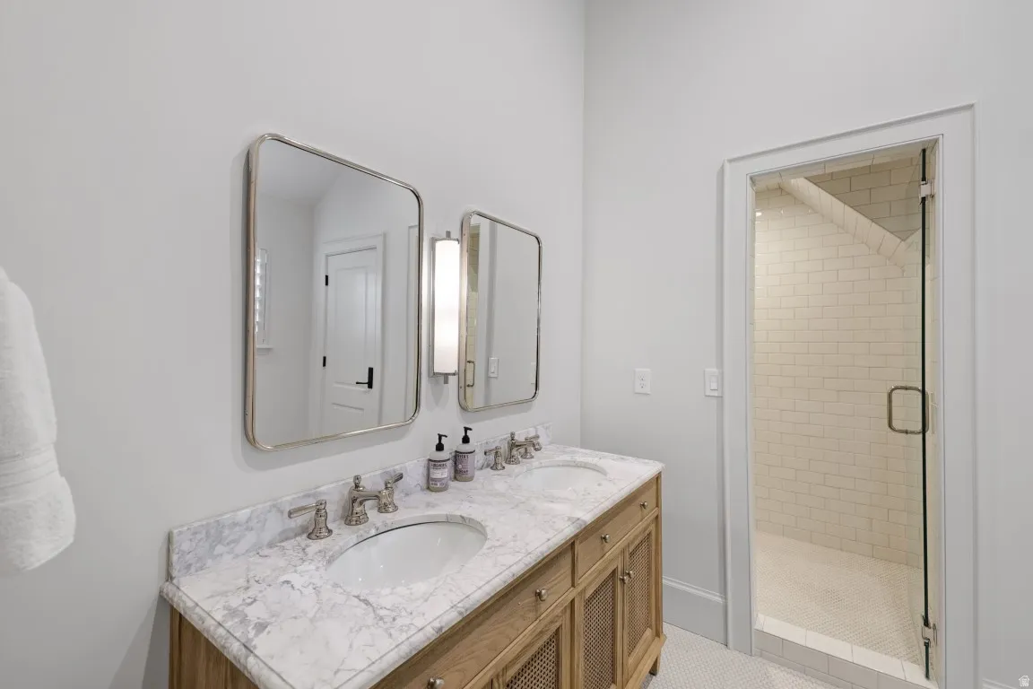 Dual vanity with a stone countertop and undermount sinks