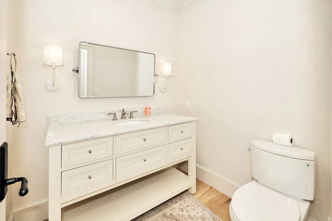 Vanity with stone countertop, undermount sink, brushed nickel faucet, and integrated storage drawers