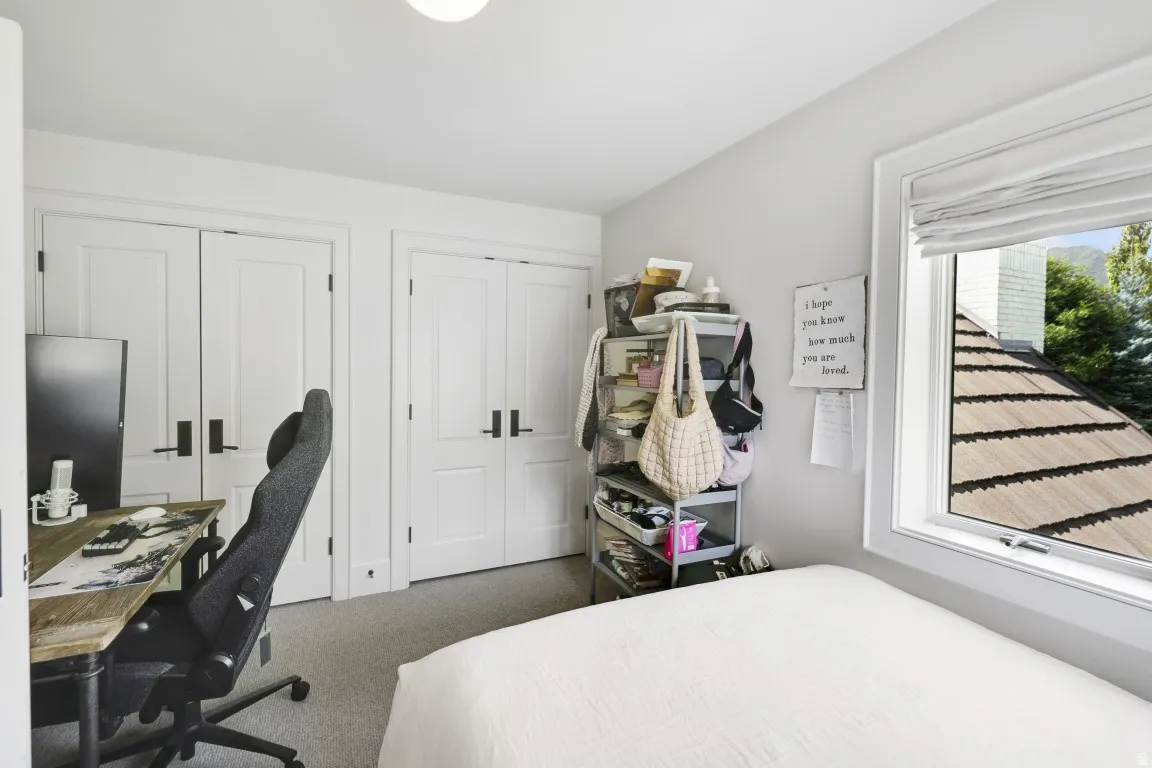 Room featuring light gray walls, white trim, and a window with white blinds