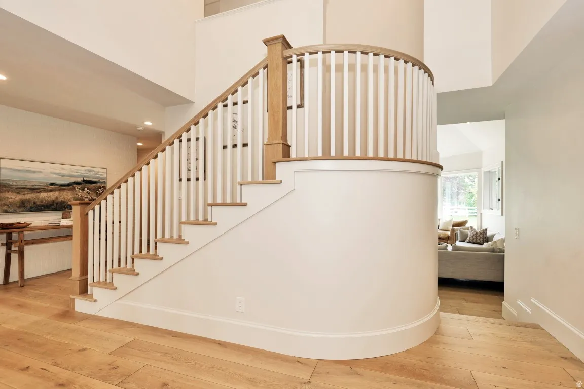 Curved staircase with wood-finish treads and white balusters