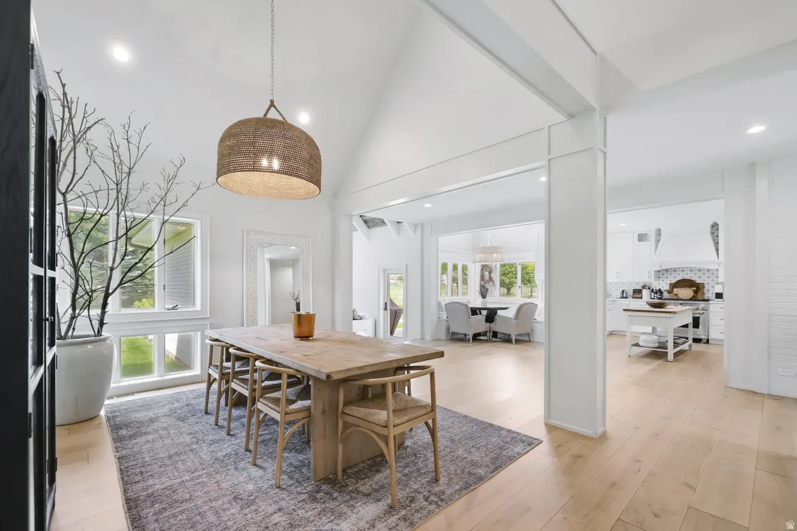 Vaulted ceiling, recessed lighting, large windows, wood-finish flooring, open-concept layout