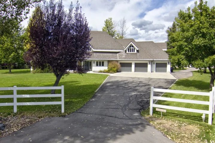 Single-story residence with a gray shingle roof, white siding, and a three-car garage