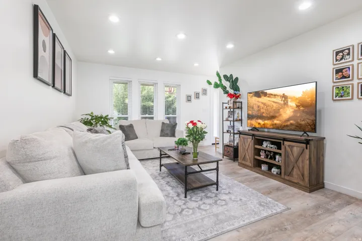 Recessed lighting, wood-finish flooring, multiple windows.