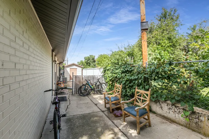 Exterior brick siding with a concrete patio