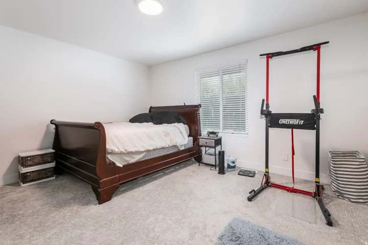 Recessed lighting, light-toned carpeting, and a window with horizontal blinds