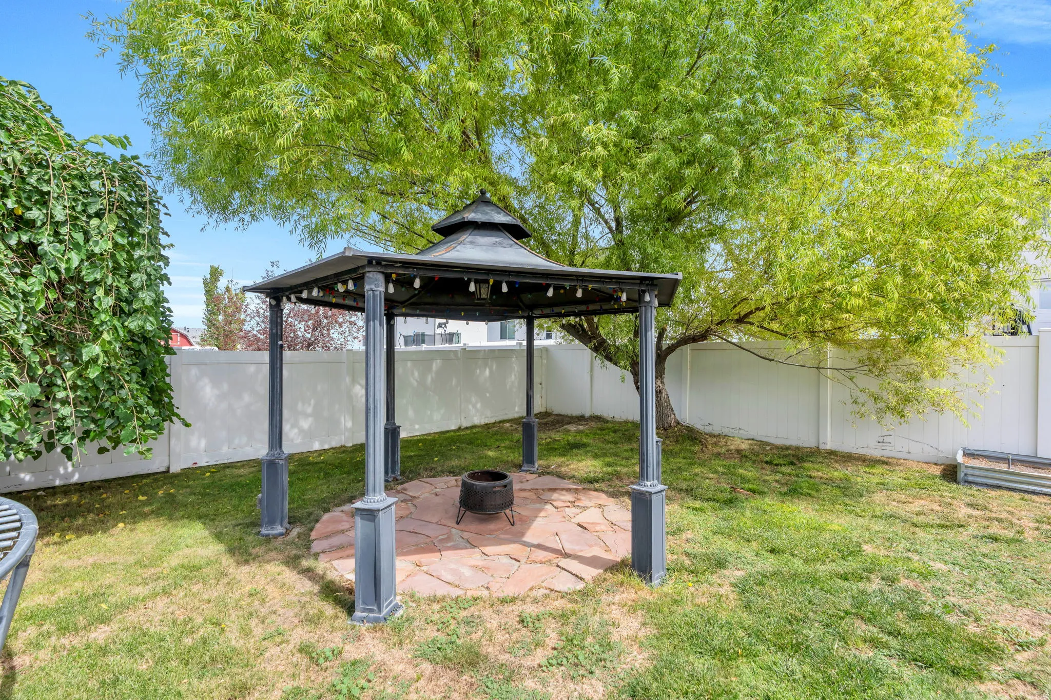 Gazebo with string lighting and flagstone patio
