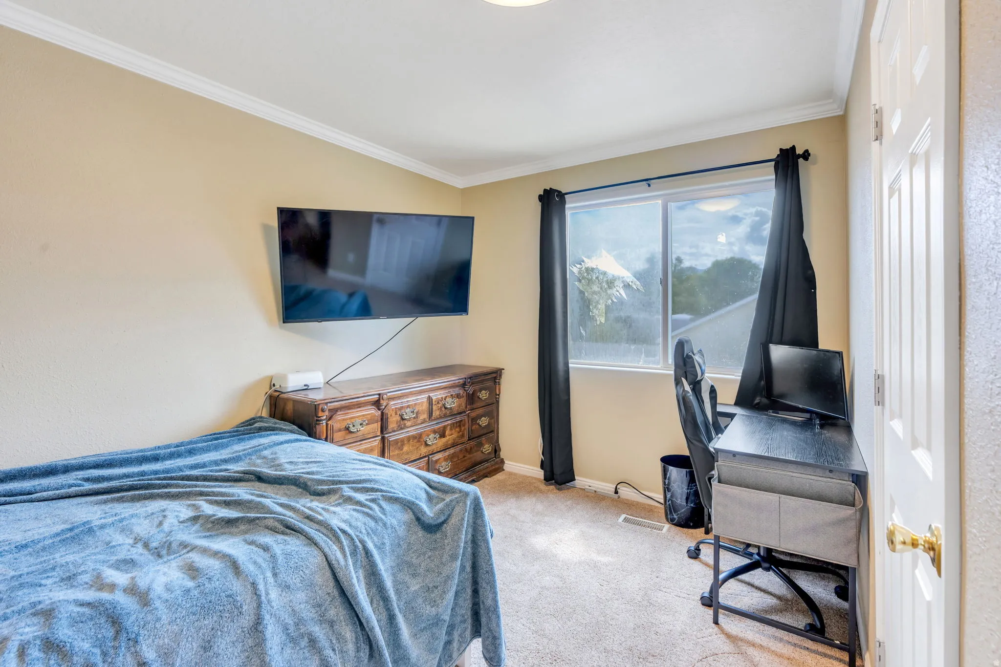 Wall-mounted television with visible cabling