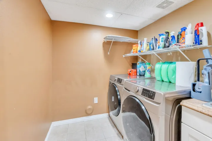 Tile flooring, white baseboards, and overhead lighting