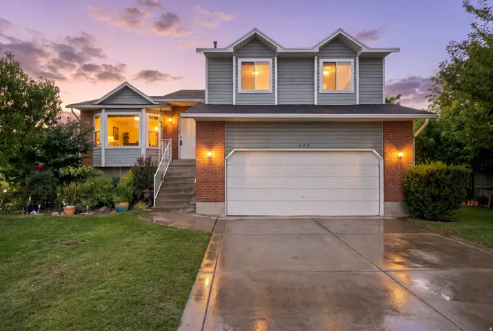 Exterior featuring mixed material siding, a bay window, and an attached garage