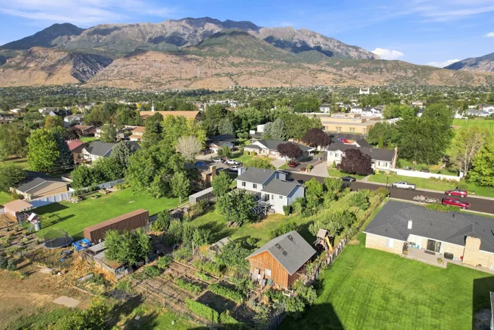 Expansive property featuring a large backyard, mature trees, and mountain scenery