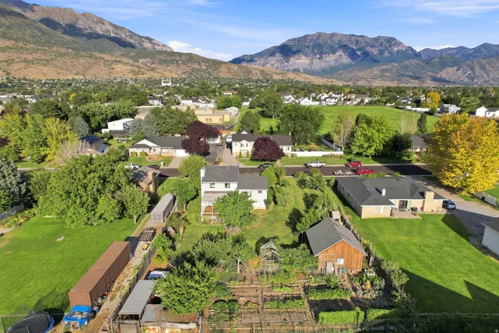 Expansive property featuring a mature garden, a detached shed, and a large green lawn