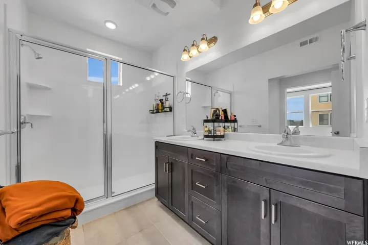 Dual vanity with gray wood-finish cabinetry and integrated sinks