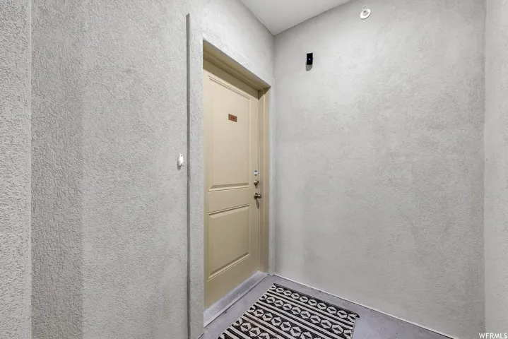 Textured wall finish, panel door, and flush-mount ceiling light