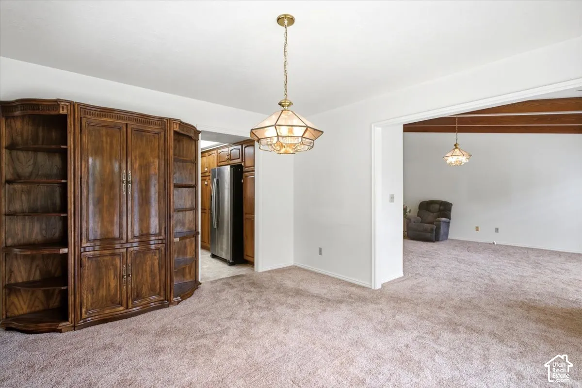 Built-in wood cabinetry with shelving, recessed lighting, and an overhead light fixture